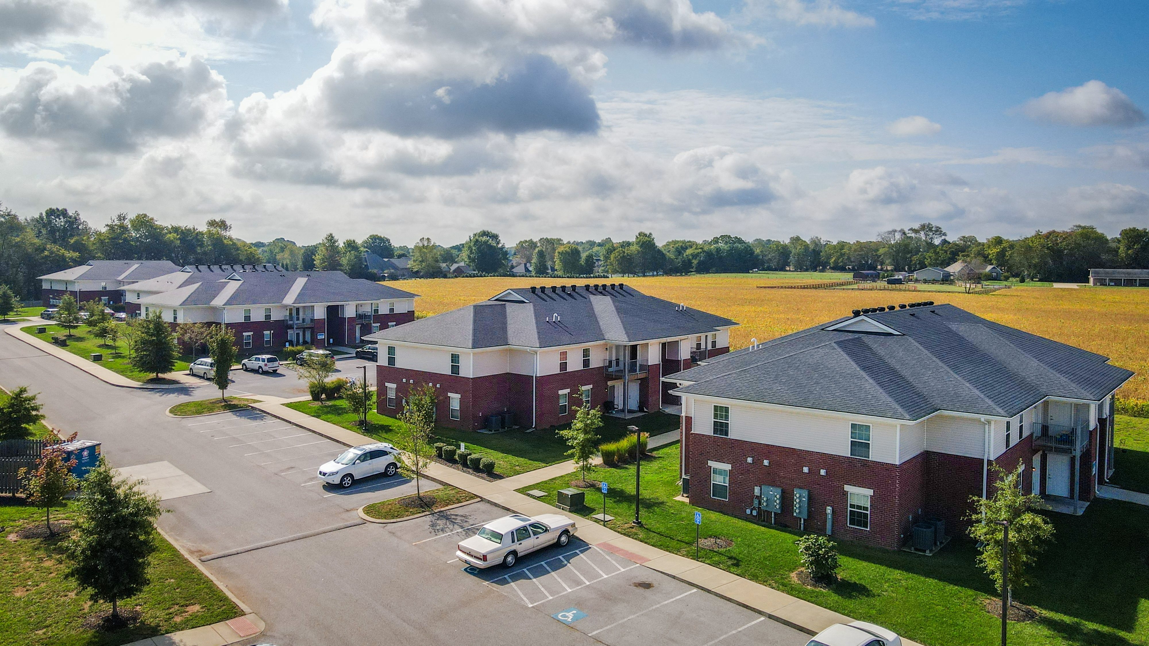 an aerial view of a neighborhood of houses with cars parked
